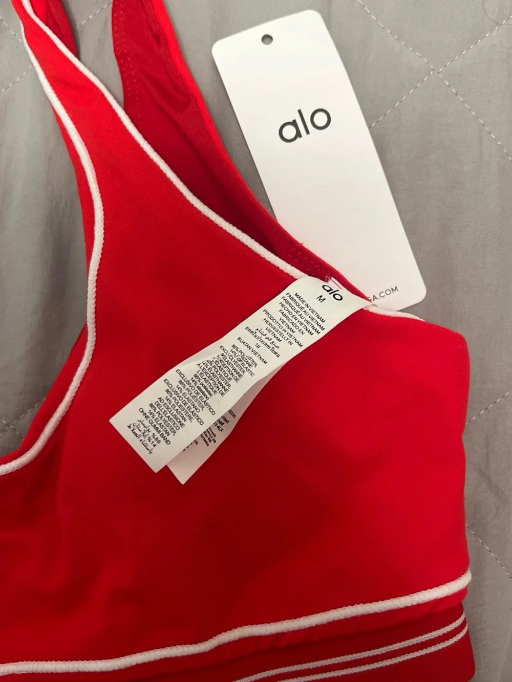 ALO Yoga red sports bra and leggings set with white piping
